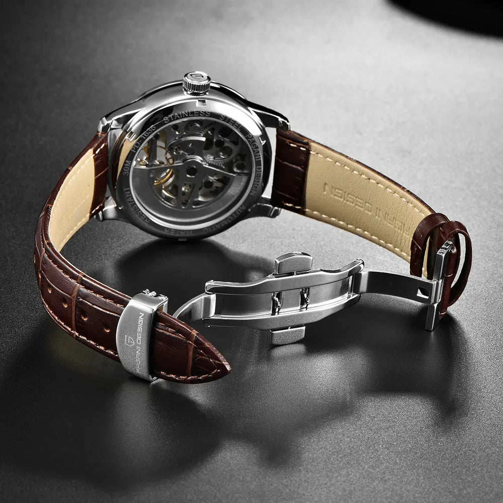 Watch with brown leather strap and silver case on a dark surface